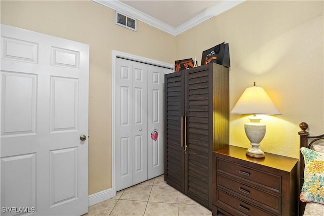 interior space featuring light tile patterned floors, a closet, and crown molding