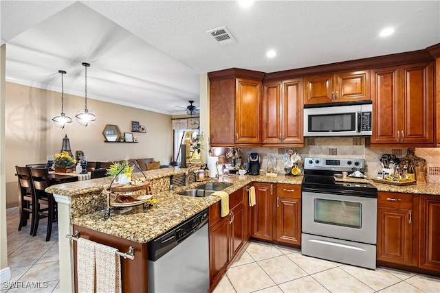 kitchen featuring appliances with stainless steel finishes, decorative light fixtures, sink, kitchen peninsula, and ceiling fan