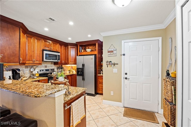 kitchen featuring kitchen peninsula, light tile patterned flooring, stainless steel appliances, ornamental molding, and light stone counters