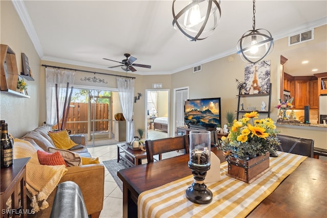 dining space with ceiling fan, light tile patterned flooring, and crown molding