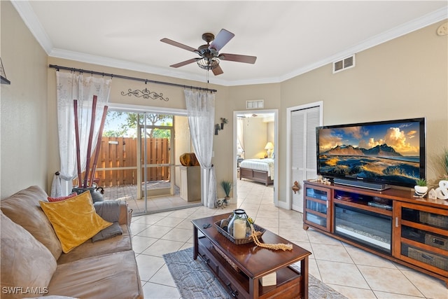 tiled living room with ceiling fan and crown molding