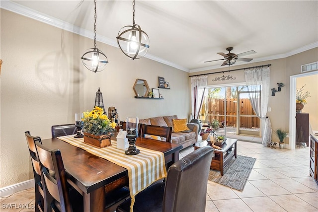 tiled dining space with ceiling fan and ornamental molding