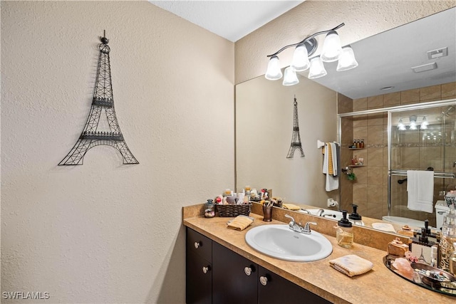 bathroom with vanity and an enclosed shower