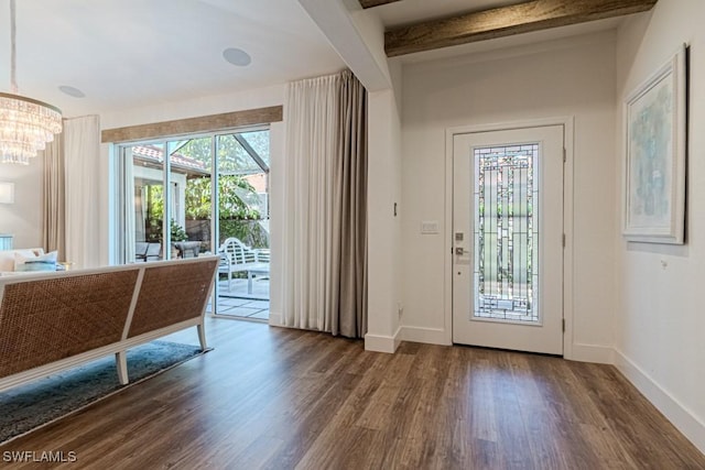 interior space featuring beamed ceiling, dark hardwood / wood-style floors, and a notable chandelier