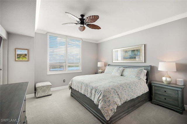 bedroom featuring ceiling fan, crown molding, and light carpet