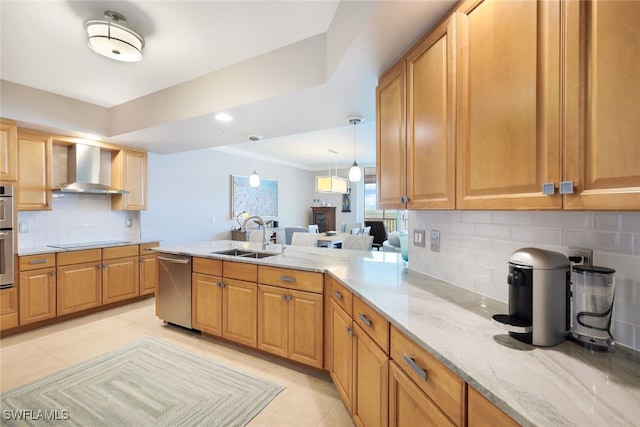 kitchen with sink, wall chimney exhaust hood, decorative backsplash, light stone countertops, and stainless steel appliances