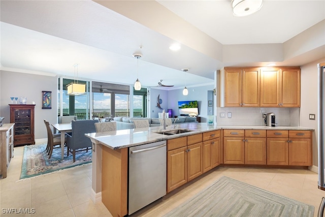 kitchen with sink, tasteful backsplash, stainless steel dishwasher, kitchen peninsula, and pendant lighting