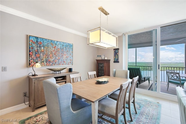 tiled dining room with floor to ceiling windows and crown molding