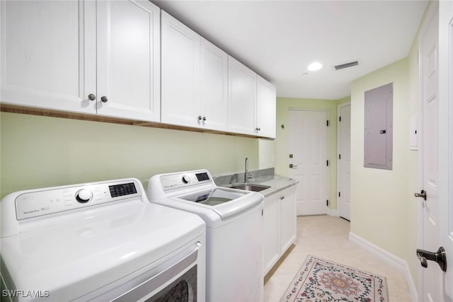 clothes washing area with sink, cabinets, independent washer and dryer, electric panel, and light tile patterned floors