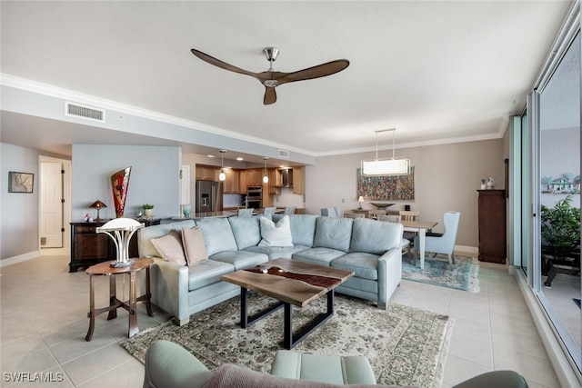 living room featuring ceiling fan, light tile patterned flooring, and ornamental molding