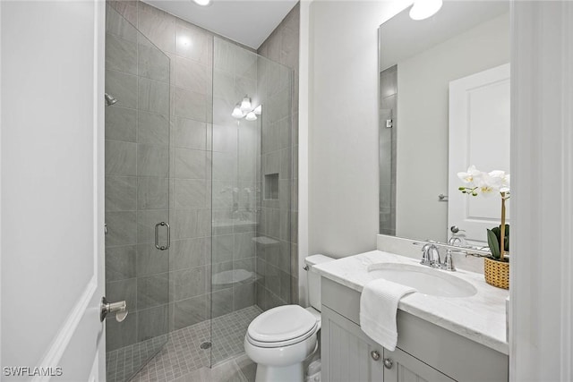 bathroom with vanity, toilet, and walk in shower