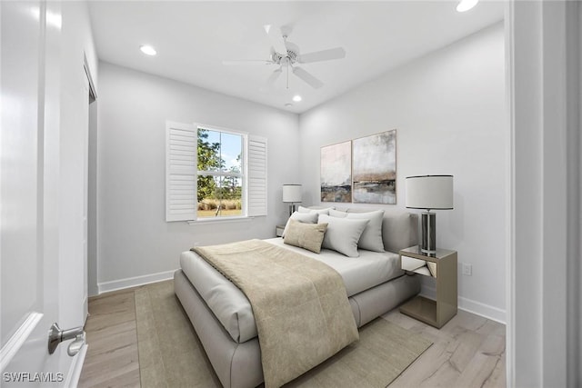 bedroom with ceiling fan and light hardwood / wood-style floors