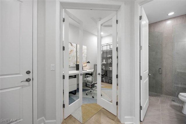 bathroom with tile patterned floors, an enclosed shower, and toilet