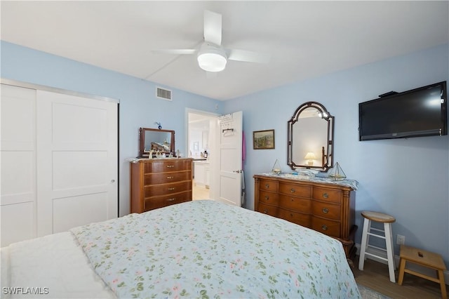 bedroom with hardwood / wood-style floors, a closet, and ceiling fan