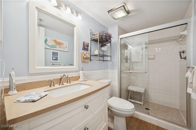 bathroom with toilet, vanity, and walk in shower