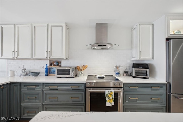 kitchen with decorative backsplash, appliances with stainless steel finishes, gray cabinets, white cabinetry, and range hood