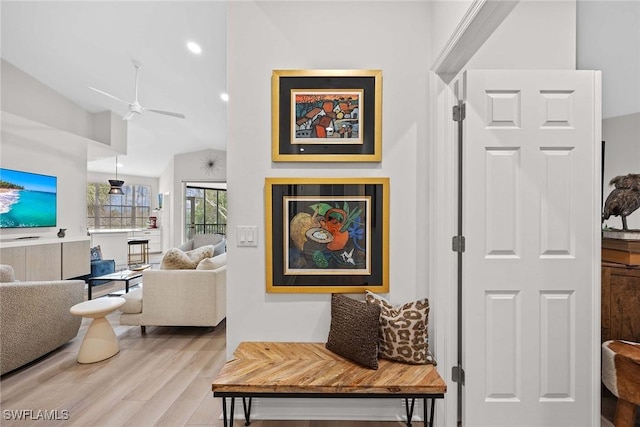 hall featuring high vaulted ceiling and wood-type flooring