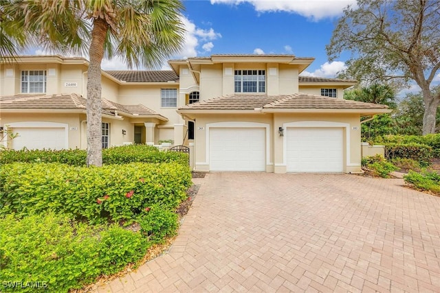 mediterranean / spanish-style house with a garage