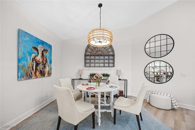 dining room with a chandelier and wood-type flooring