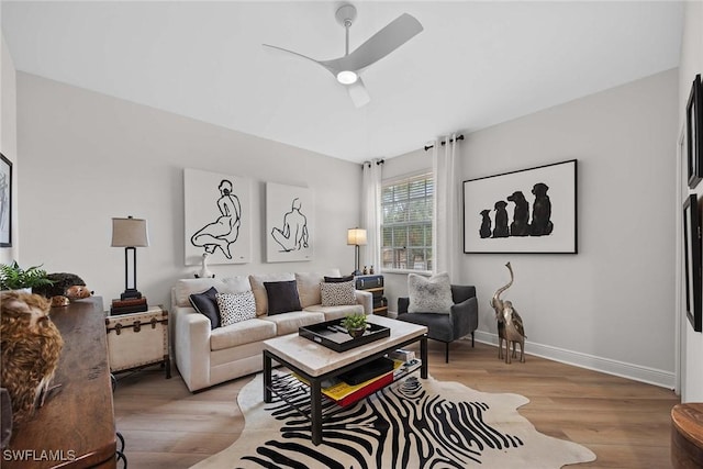 living room featuring light hardwood / wood-style floors and ceiling fan