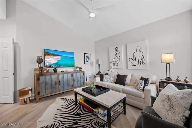 living room featuring light hardwood / wood-style flooring, vaulted ceiling, and ceiling fan