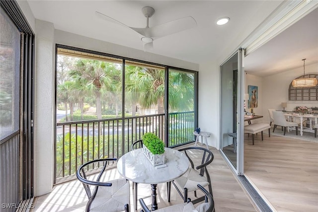 sunroom featuring ceiling fan and lofted ceiling