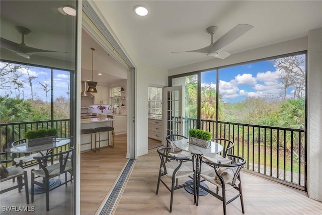 sunroom with a wealth of natural light, ceiling fan, and sink