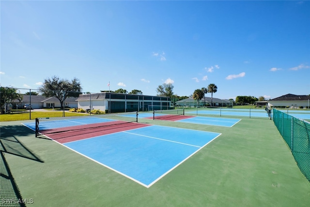 view of tennis court with basketball hoop