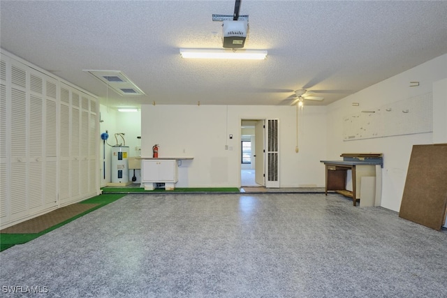 garage featuring ceiling fan, a garage door opener, and water heater