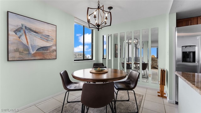 tiled dining room with a healthy amount of sunlight and a notable chandelier