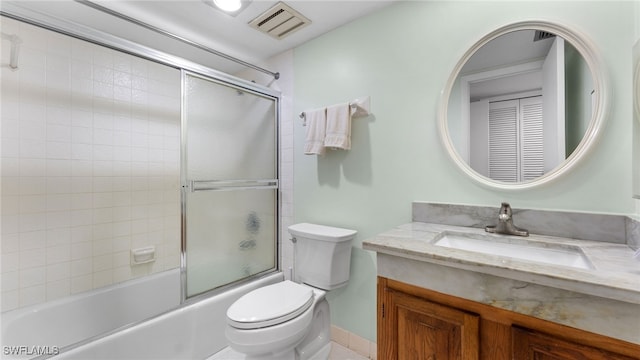 full bathroom featuring enclosed tub / shower combo, vanity, and toilet