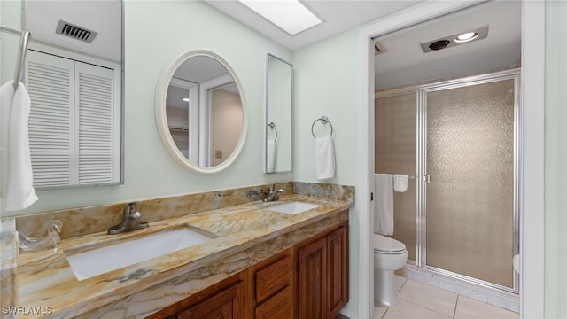 bathroom with tile patterned floors, toilet, an enclosed shower, and vanity