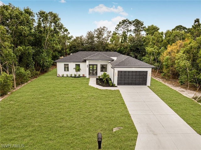 view of front of house featuring a garage and a front lawn