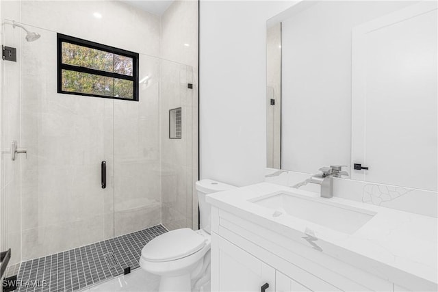 bathroom featuring toilet, an enclosed shower, and vanity