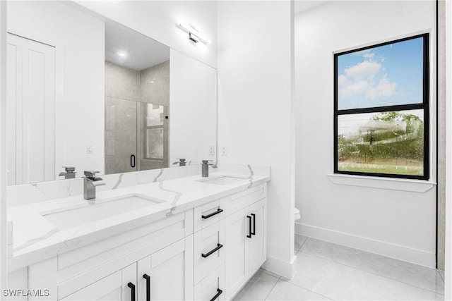 bathroom with tile patterned flooring, toilet, a shower with door, and vanity