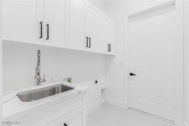 laundry room with washer hookup, light tile patterned floors, sink, hookup for an electric dryer, and cabinets