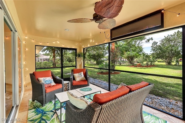 sunroom / solarium featuring ceiling fan