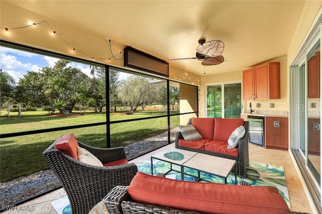 sunroom featuring ceiling fan and wine cooler