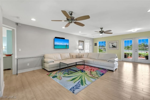 living room with ceiling fan, light wood-type flooring, and french doors