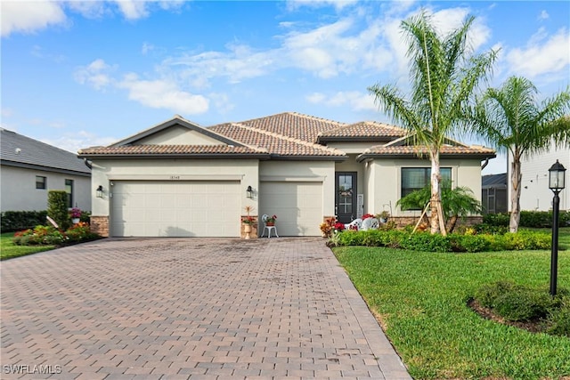 view of front of property with a front yard and a garage