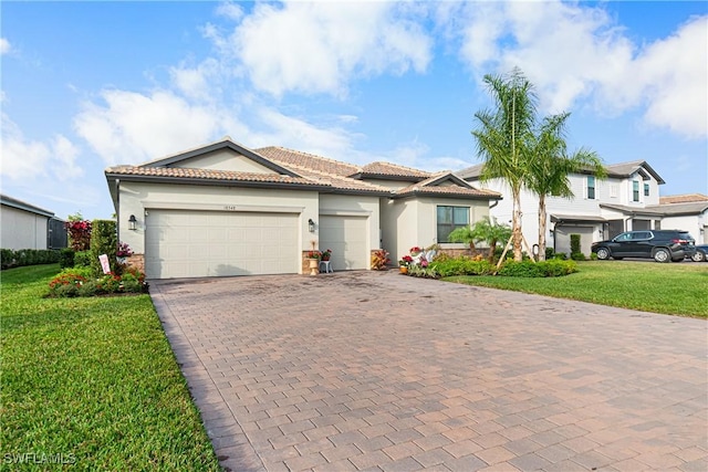 view of front of home with a garage and a front yard