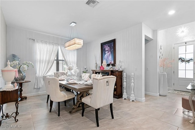 tiled dining area featuring an inviting chandelier