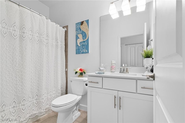 bathroom with tile patterned floors, vanity, and toilet