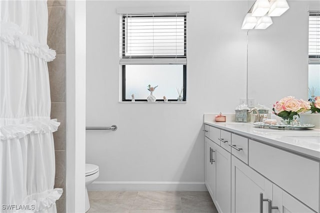 bathroom with tile patterned flooring, vanity, and toilet