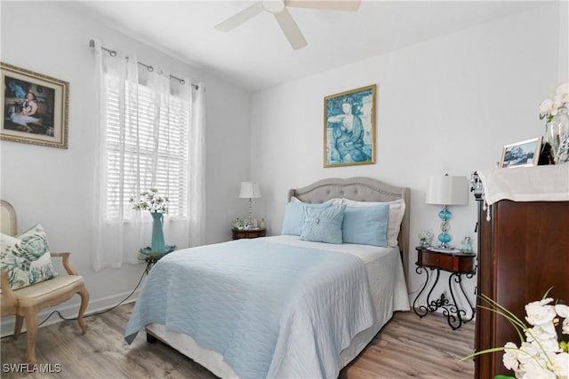 bedroom with light hardwood / wood-style floors and ceiling fan