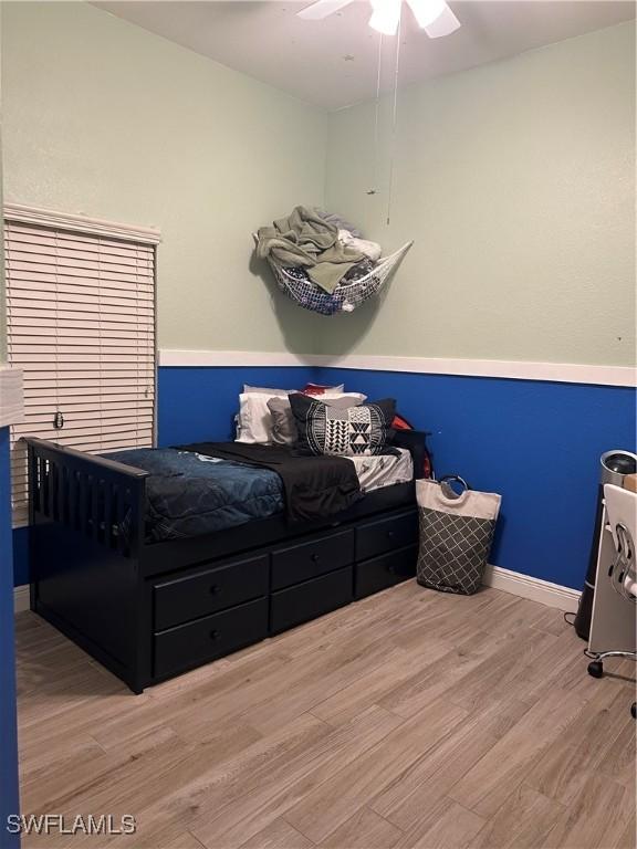 bedroom with ceiling fan and light hardwood / wood-style floors