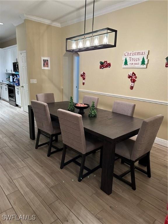 dining area with crown molding and light wood-type flooring