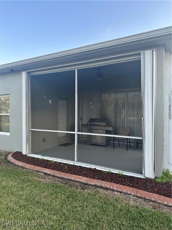 exterior space with a sunroom and a yard