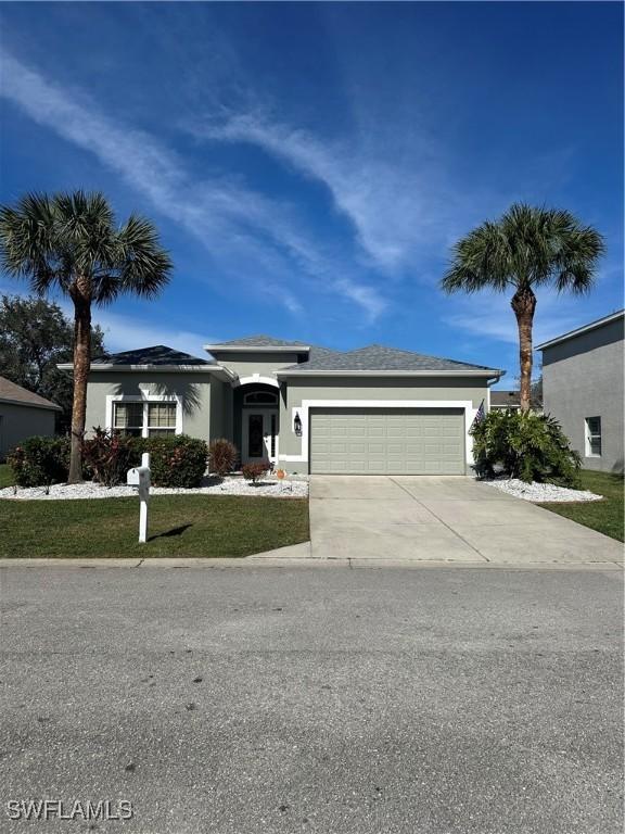 view of front of property featuring a garage and a front yard