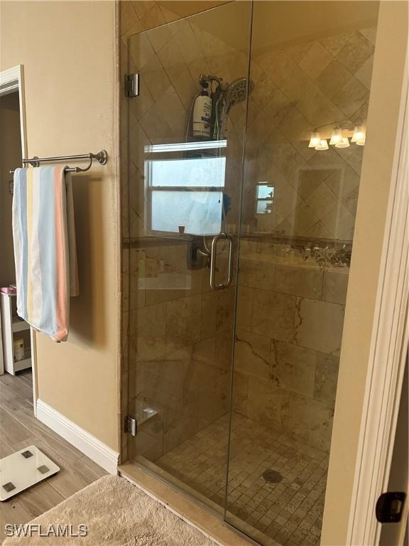 bathroom with a shower with door